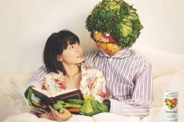 Japanese ad featuring man made of vegetables hugging woman
