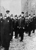 link to uniformed men wearing masks