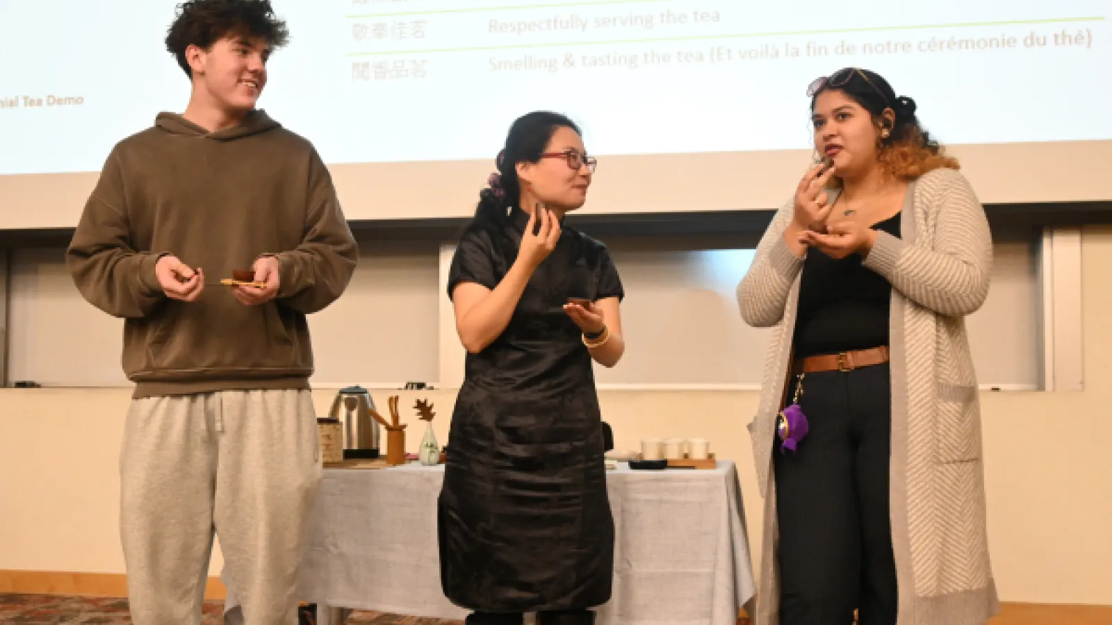 two students sampling tea with tea ceremony instructor