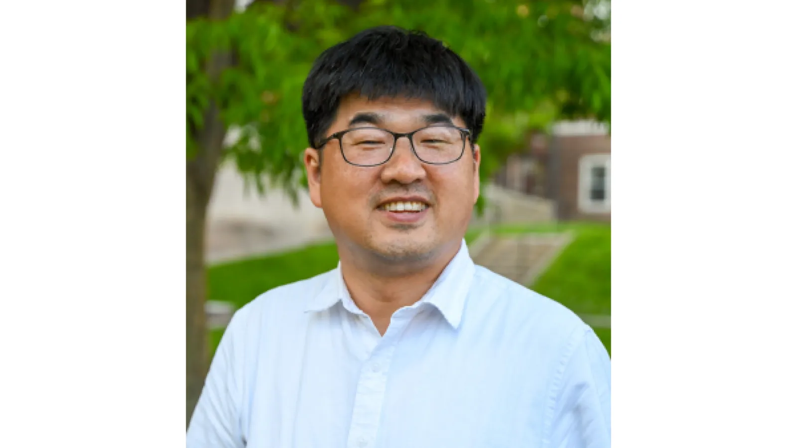 Middle aged man with short black hair and glasses