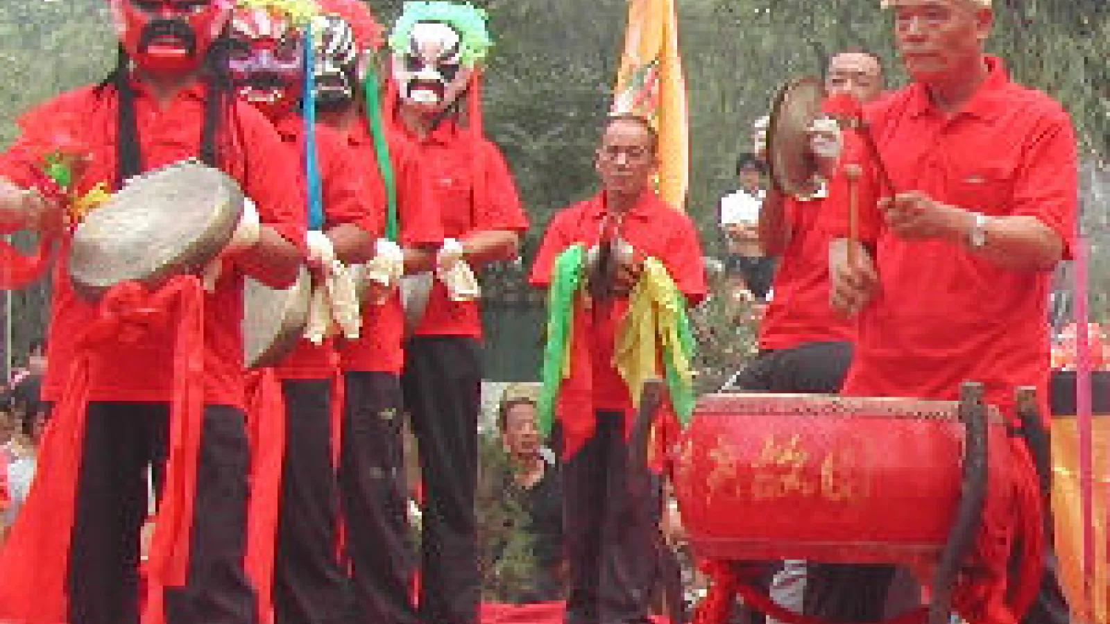 an image of musical performers wearing traditional chinese masks with drums 