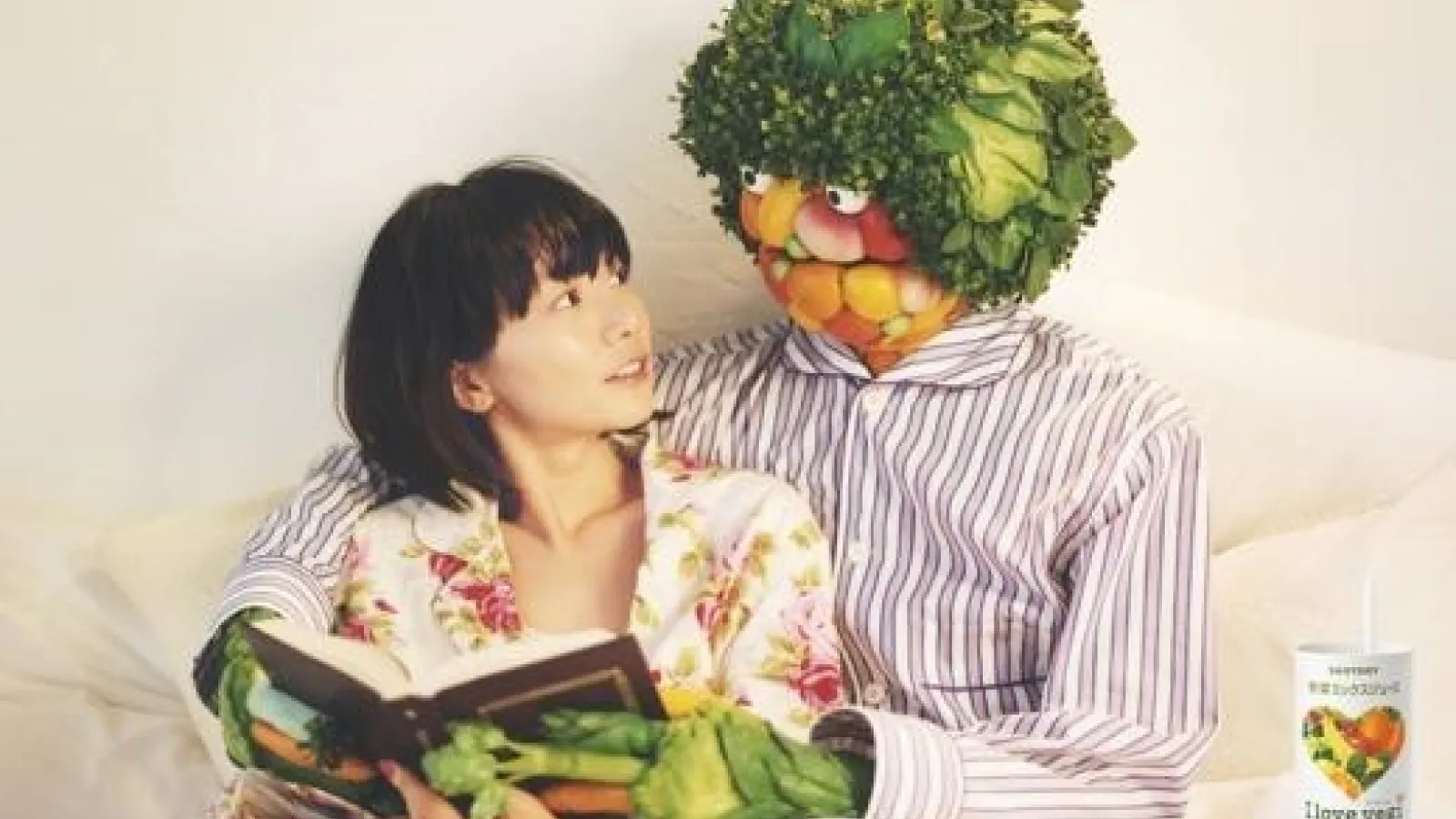Japanese ad featuring man made of vegetables hugging woman