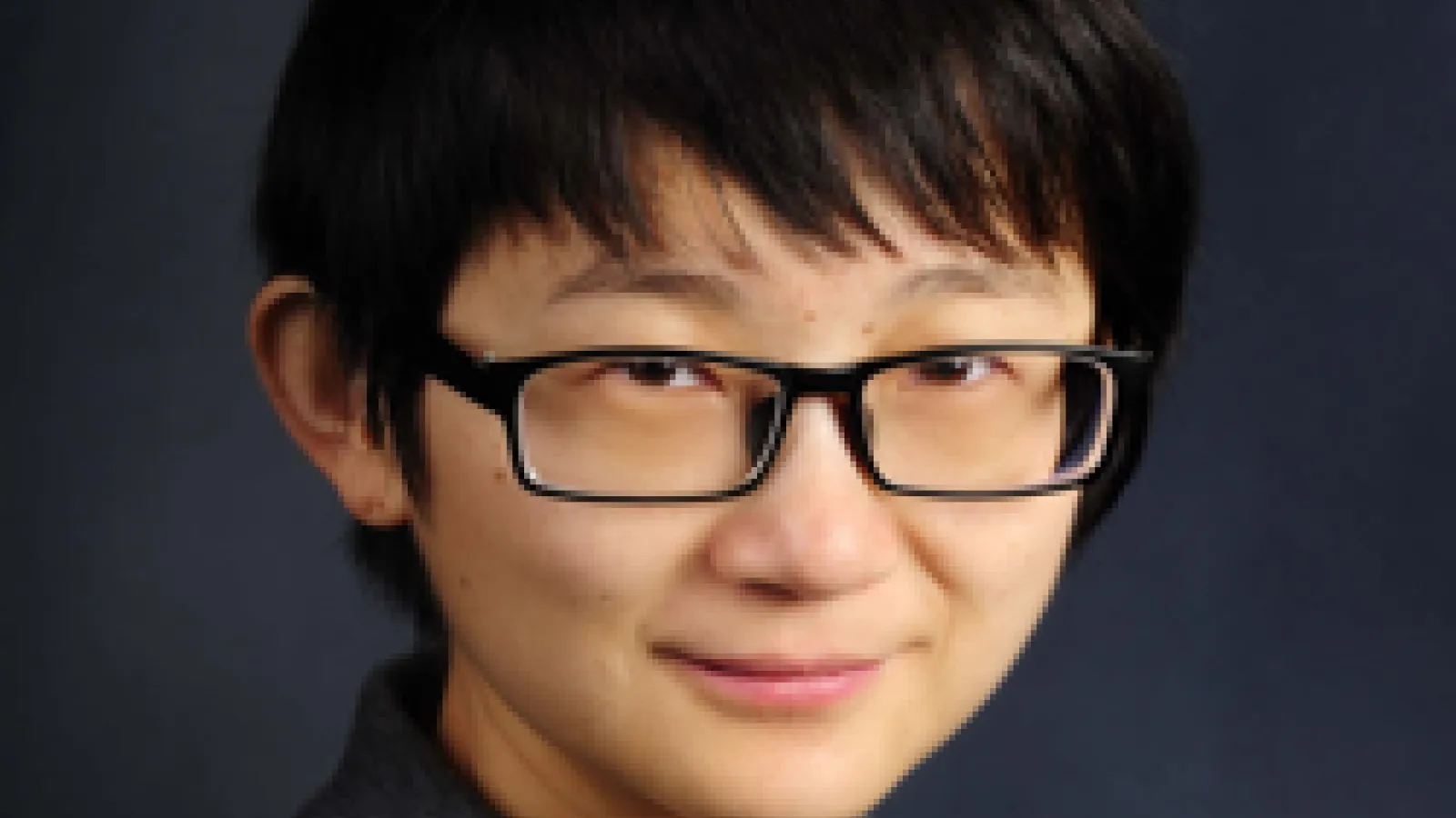 photo of Prof. Zhang Ni, a young person with glasses and short black hair