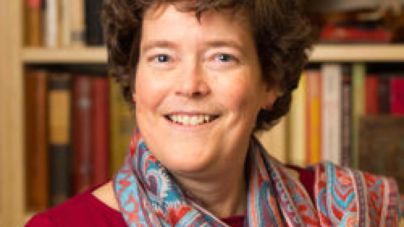 Kristin Stapleton image of a middle aged woman with gurly brown hair and a scarf