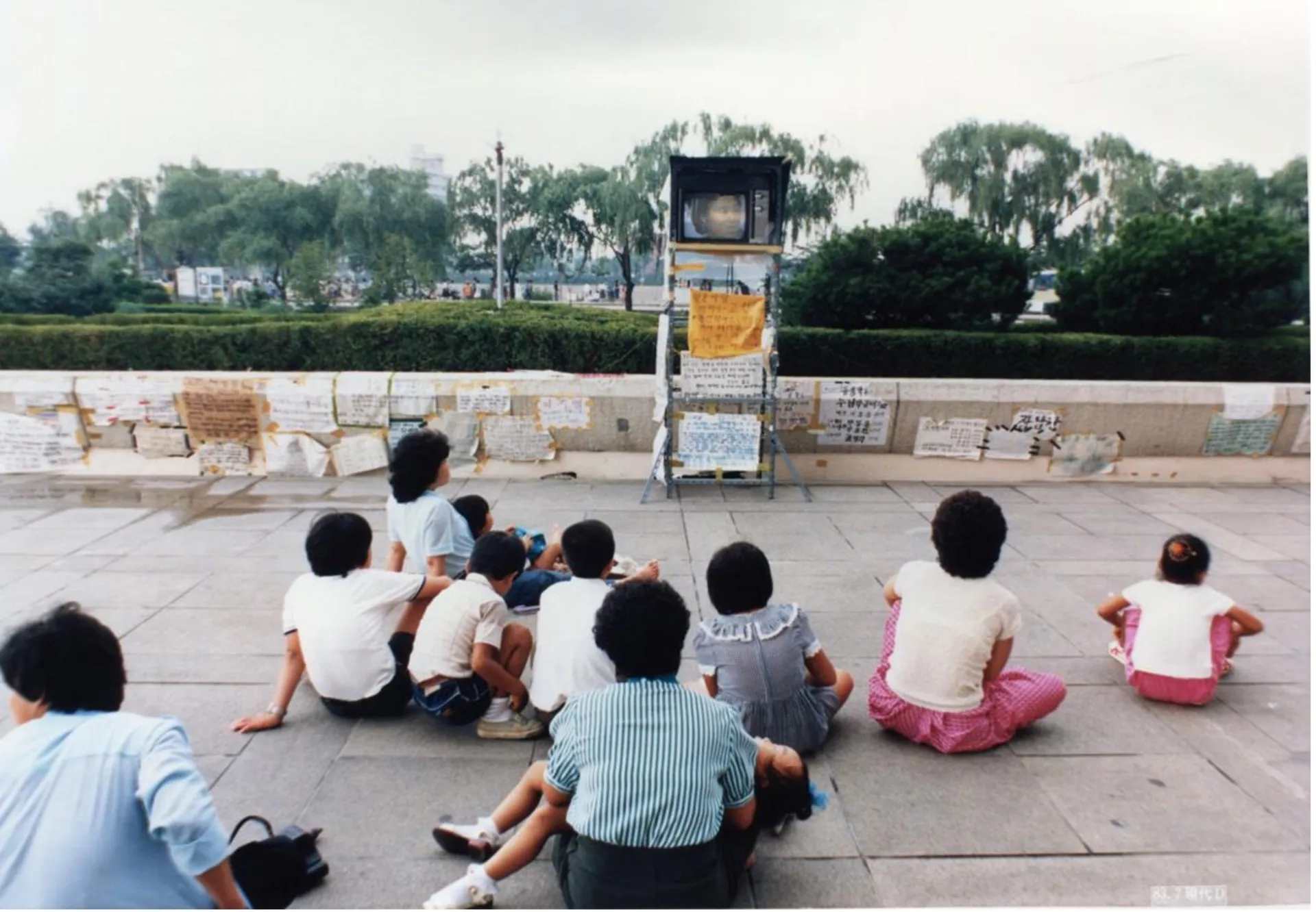 people watching television outside
