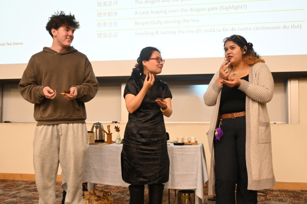 two students sampling tea with tea ceremony instructor