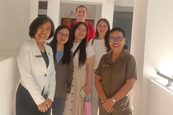students and teachers standing in a hallway