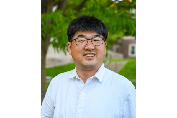 Middle aged man with short black hair and glasses