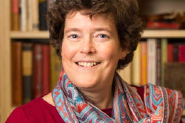 Kristin Stapleton image of a middle aged woman with gurly brown hair and a scarf