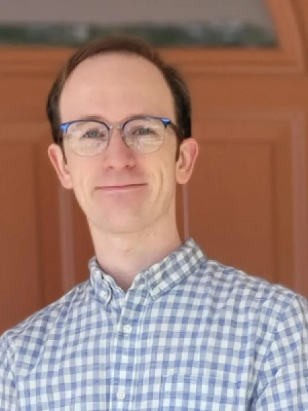 picture of man with short brown hair and glasses