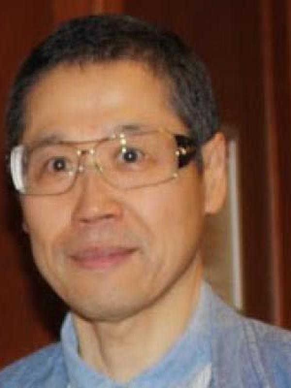 Picture of an older man with short black hair and glasses