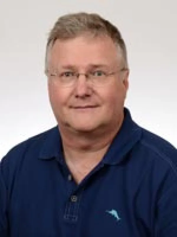 Picture of an older man with short brown hair and glasses
