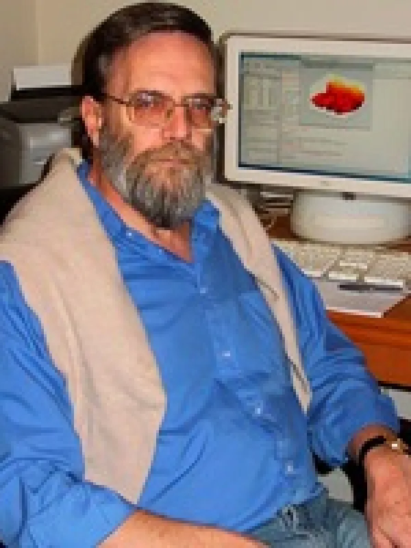 Picture of an older man with short black hair and glasses