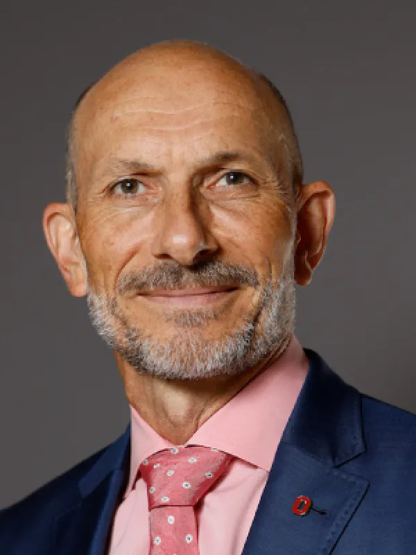 a middle aged man wearing a suit