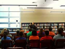 Presenter in front of audience in library